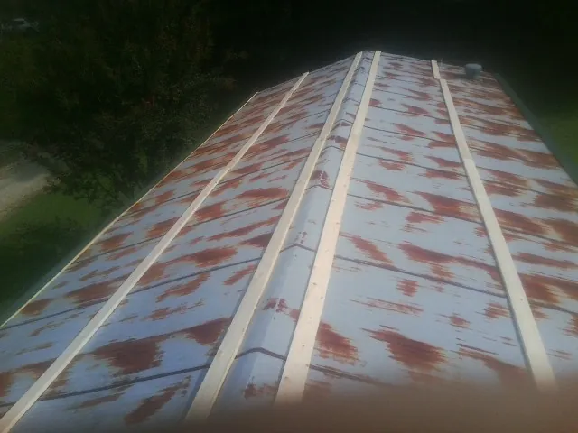 Rusted metal roof panels with new wood purlins before replacement — Storm Damage Roof Repair in Corte Madera by Roofing Brothers