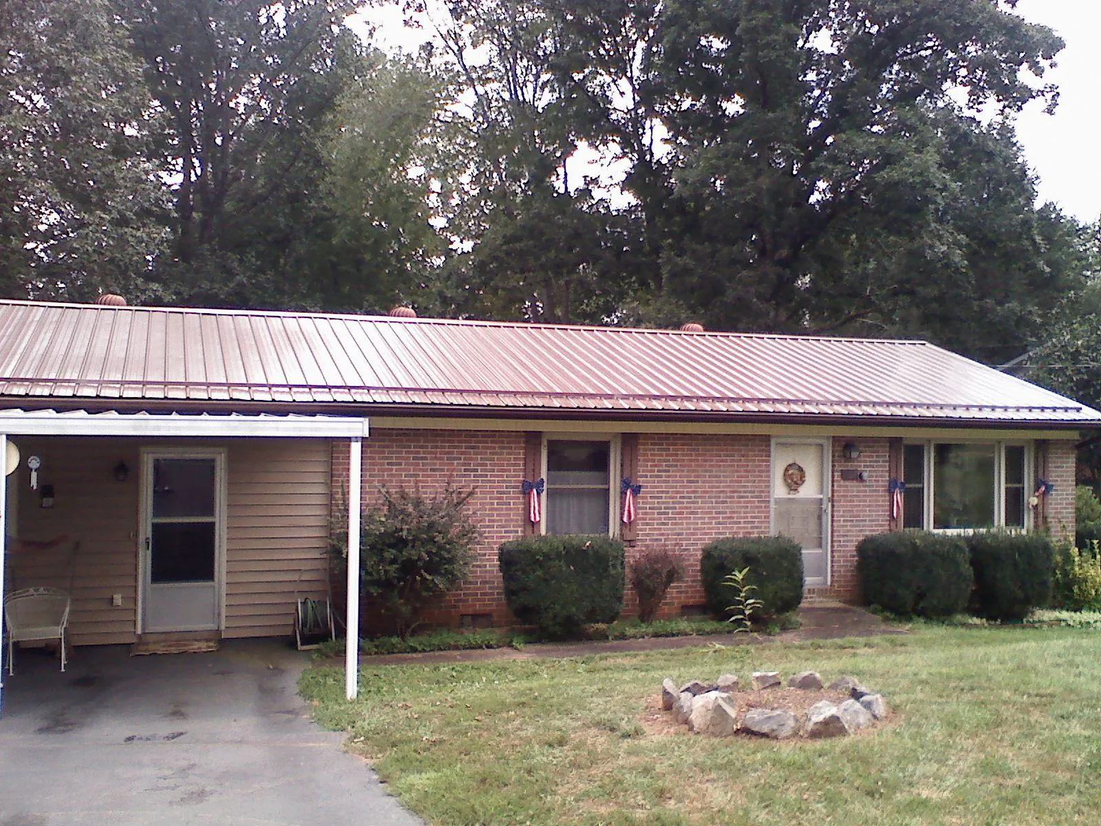 Bronze metal roof and carport on a brick ranch home — Roof Repair work by our crew in Corte Madera